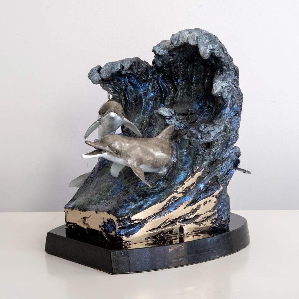 The finished bronze dolphin sculpture after patina and mounting