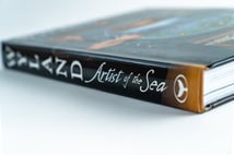 Detail of the Artist of the Sea spine with the Wyland whale-tail mark