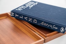 Wyland Artist of the Sea book resting in its open wooden collector's case