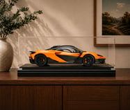 Cased McLaren 1:8 scale model displayed on a matte black Amalgam Collection Memorial Riser