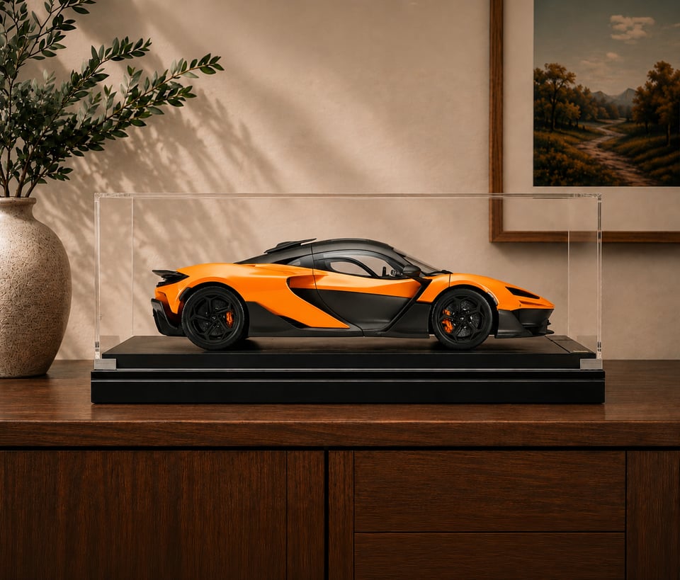 Cased McLaren 1:8 scale model displayed on a matte black Amalgam Collection Memorial Riser